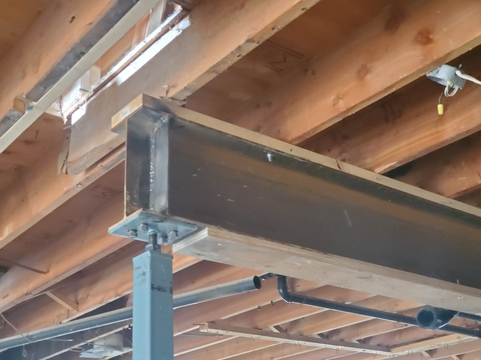 Steel beam and support post carrying floor joists