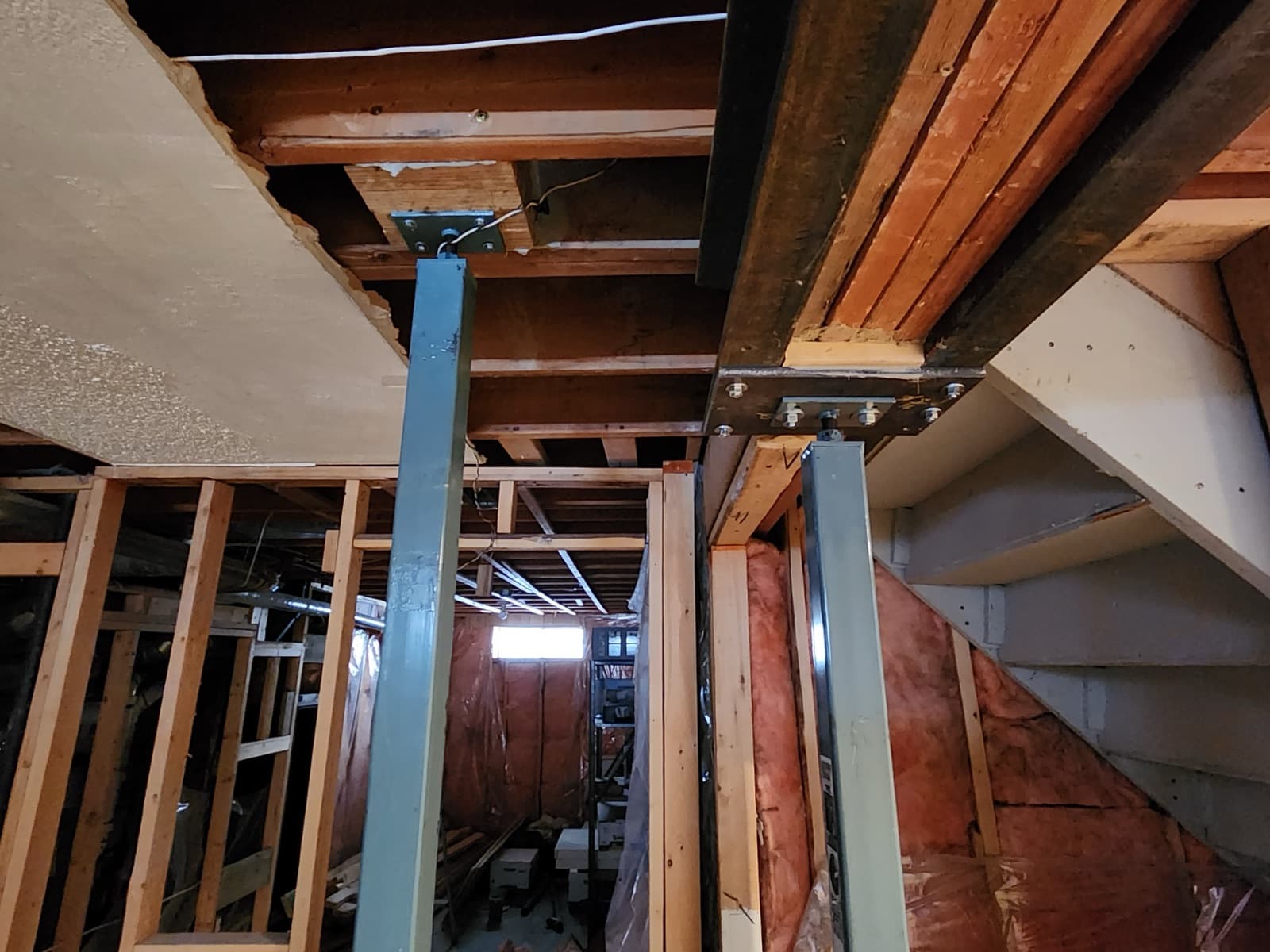 Steel support posts installed below a structural beam
